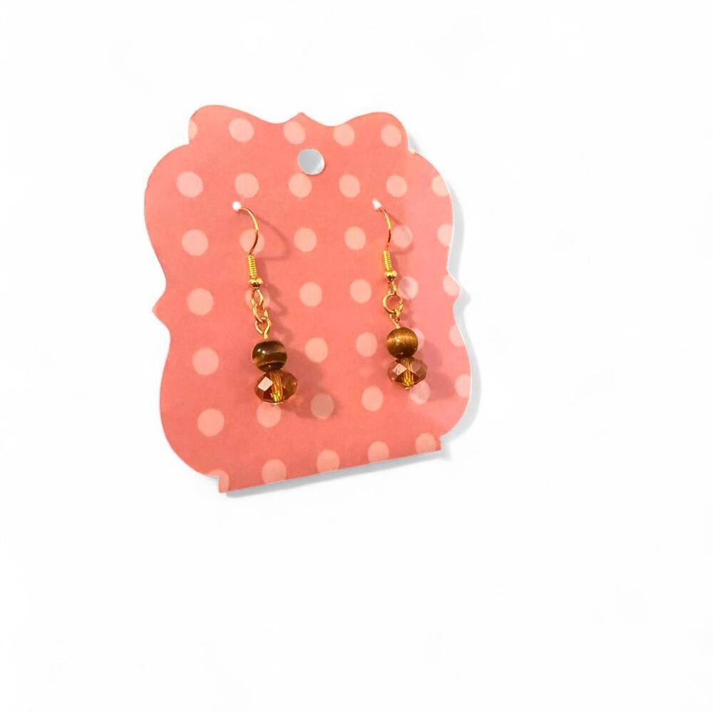 Handmade tigers eye bead and orange glass crystal earrings on a gold toned hook.